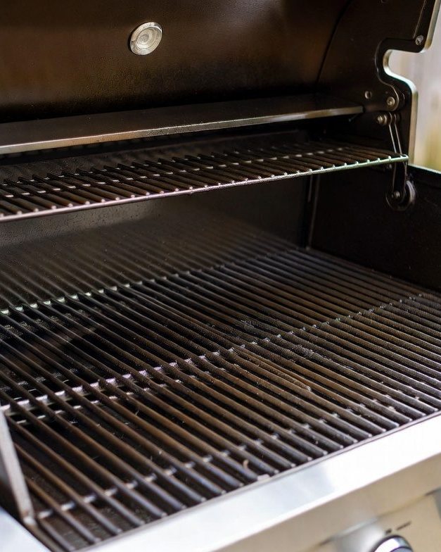 Freshly cleaned stainless steel gas grill with spotless grates